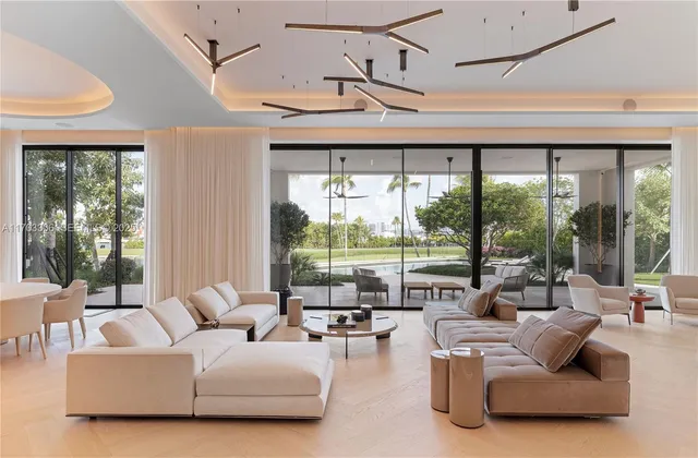 a living room with furniture and large windows