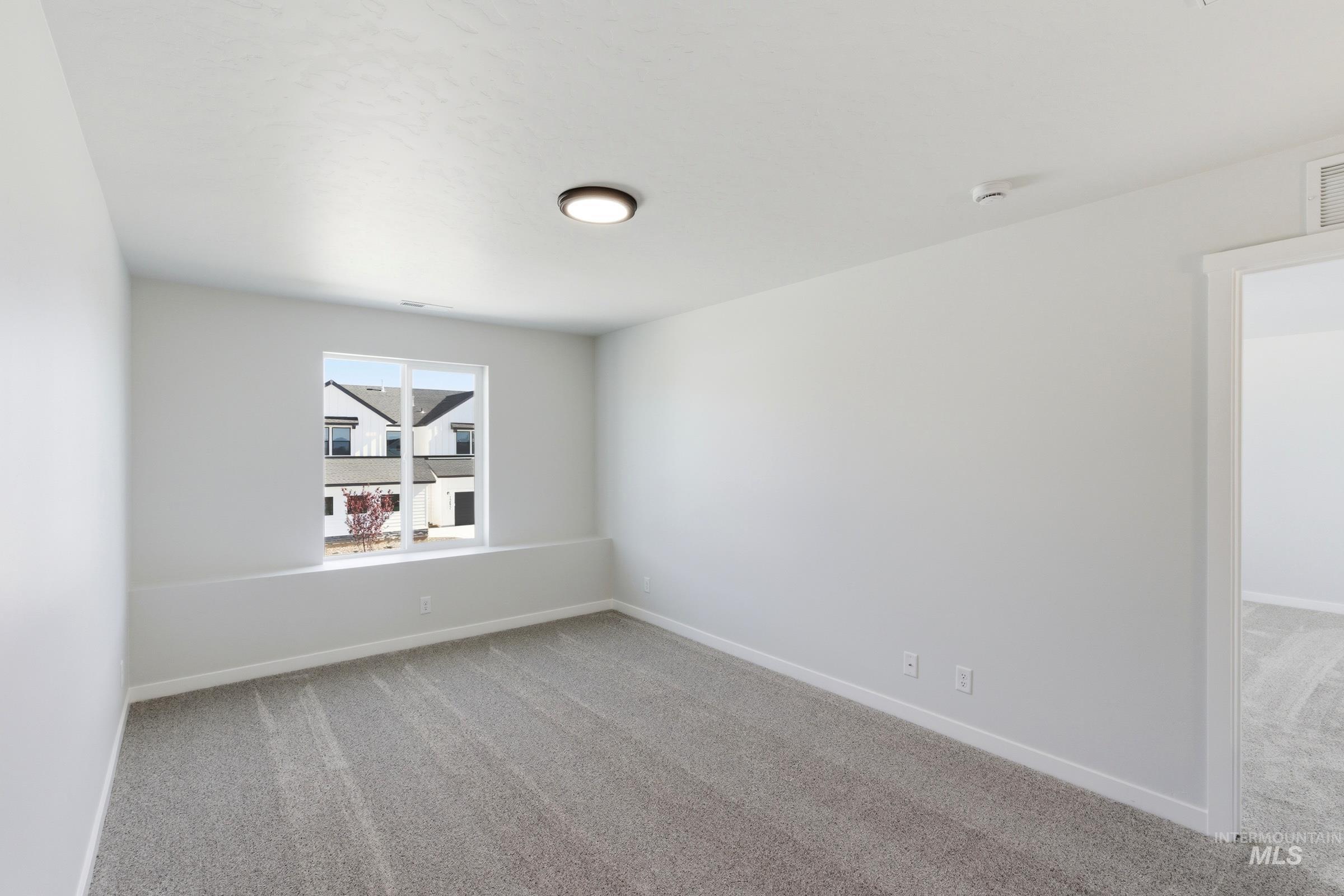 13677 Redway Court Caldwell, ID 83607 - Photo 28 of 35 Neutral interior featuring light gray carpet, white walls, and a single window offering natural illumination