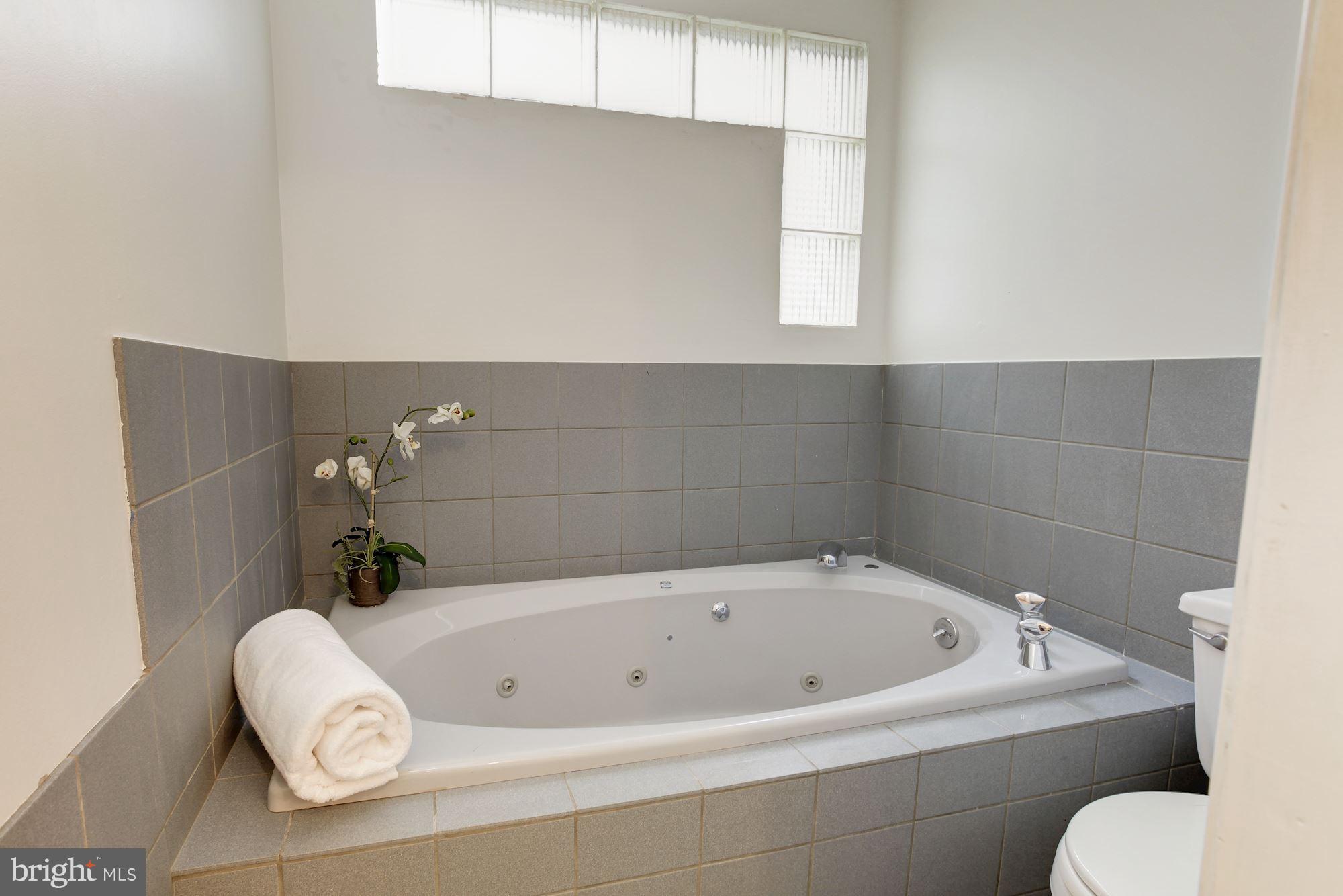 11704 Joseph Mill Road Silver Spring, MD 20906 - Photo 14 of 20 a white bath tub sitting in a bathroom