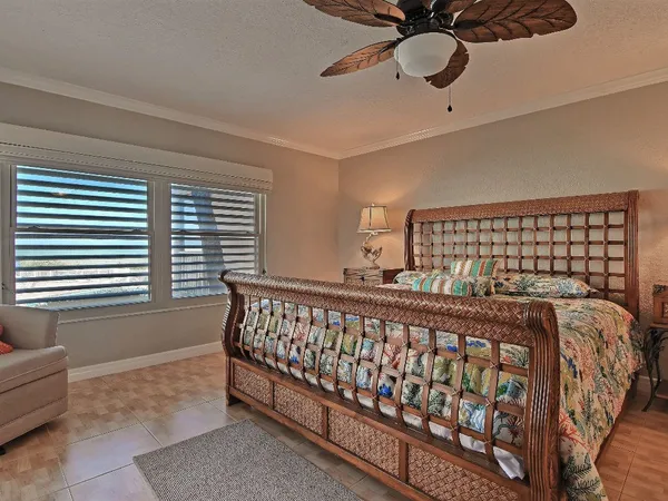 a bed sitting in a bedroom next to a window