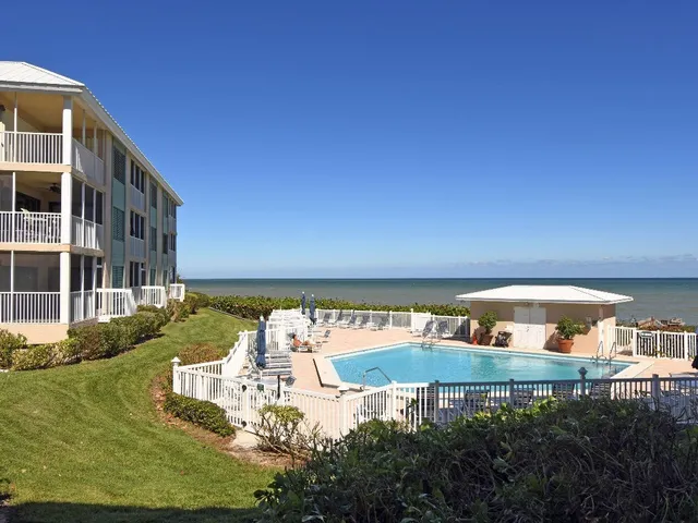 a view of swimming pool with outdoor seating and plants