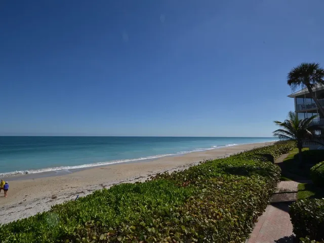 a view of a house with backyard porch and sitting area