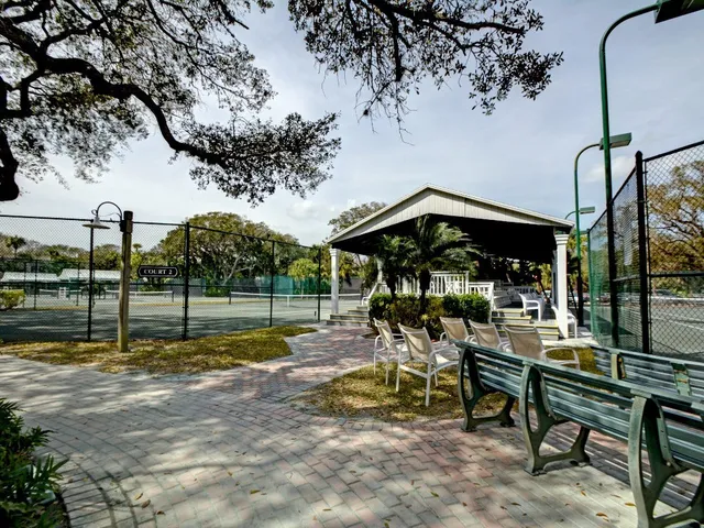 a view of a house with large trees in front of it