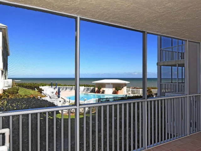 a living room with furniture wooden floor and a large window