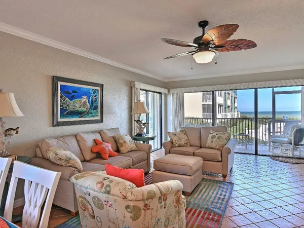 a patio with a table and chairs under an umbrella
