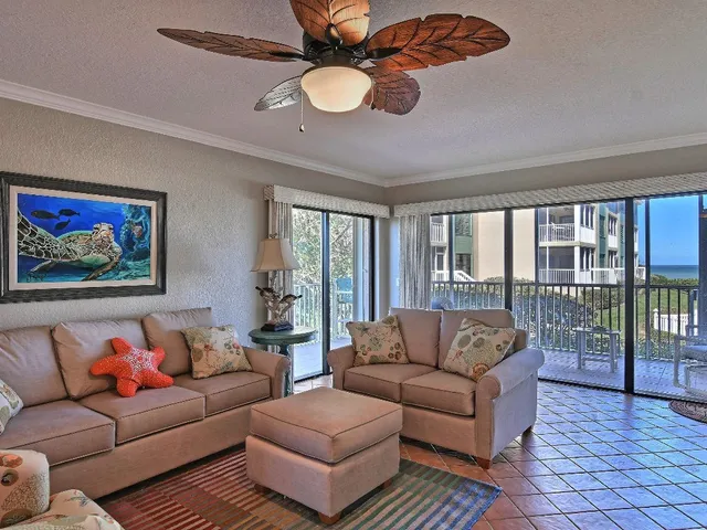 a living room with furniture ceiling fan and a rug