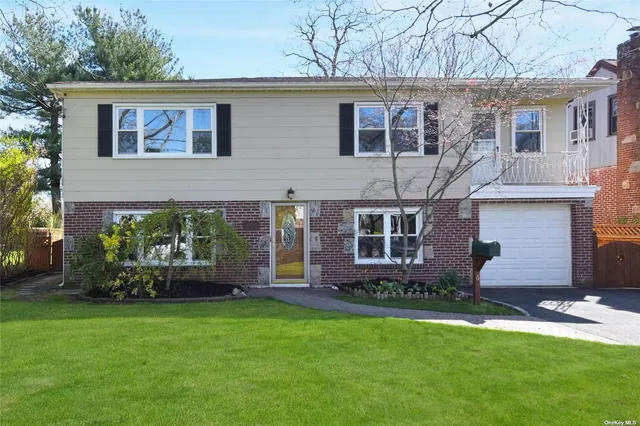 a front view of house with yard and outdoor seating