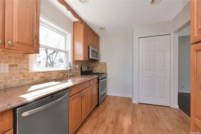 a kitchen with a sink a window and appliances