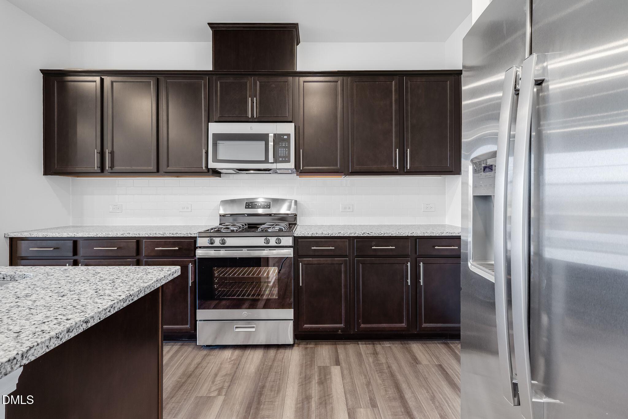 2939 Hickory Fld Drive Raleigh, NC 27616 - Photo 11 of 30 a kitchen with a refrigerator and a sink