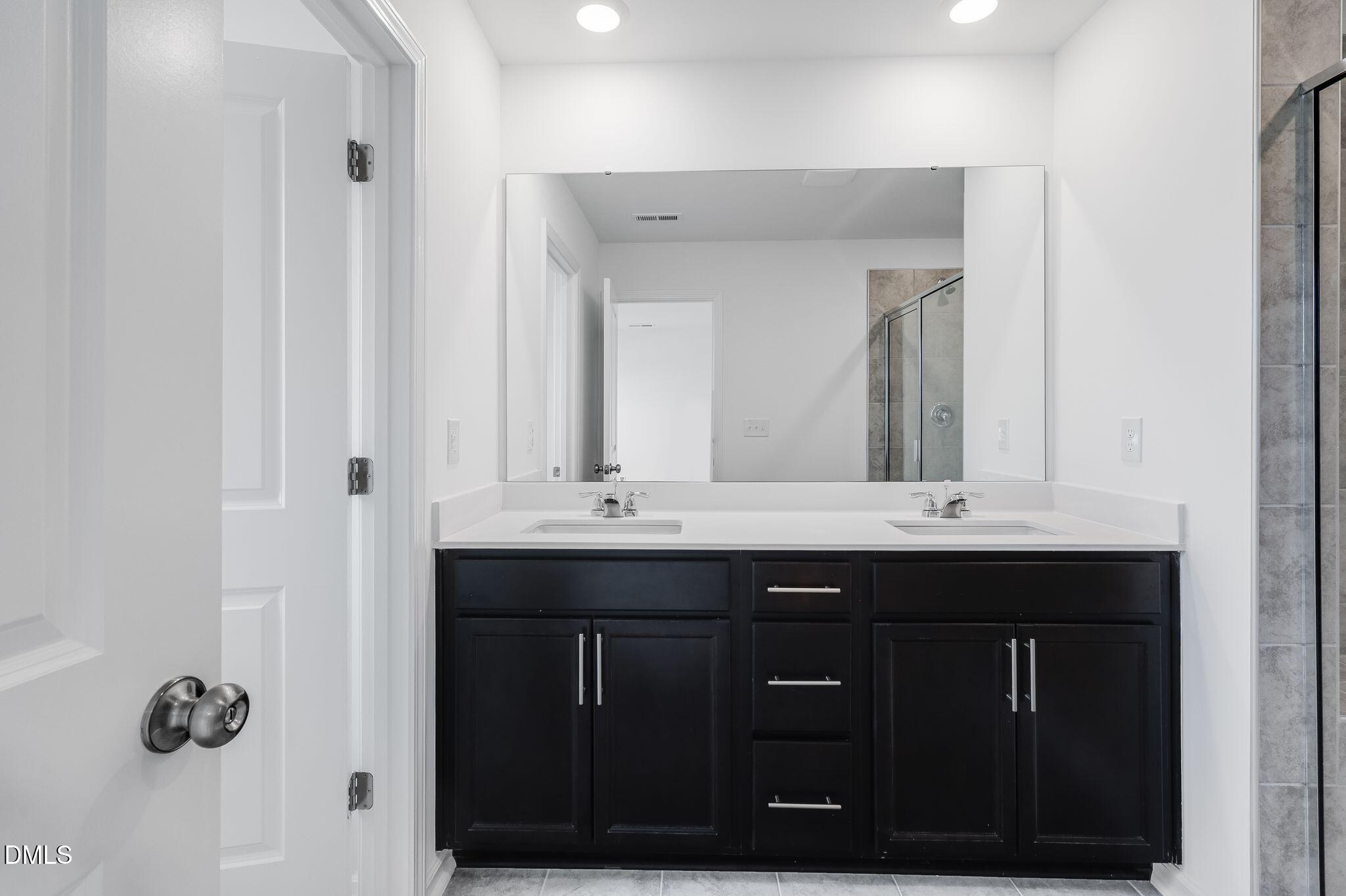 2939 Hickory Fld Drive Raleigh, NC 27616 - Photo 23 of 30 a bathroom with a sink vanity and a mirror
