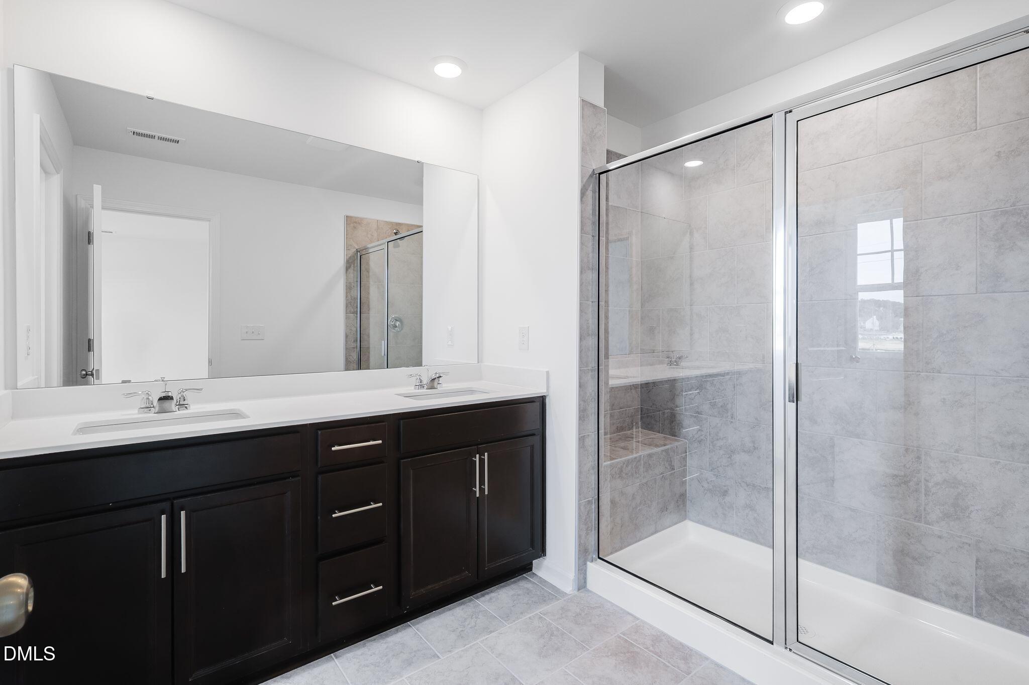 2939 Hickory Fld Drive Raleigh, NC 27616 - Photo 24 of 30 a bathroom with a double vanity sink mirror and shower