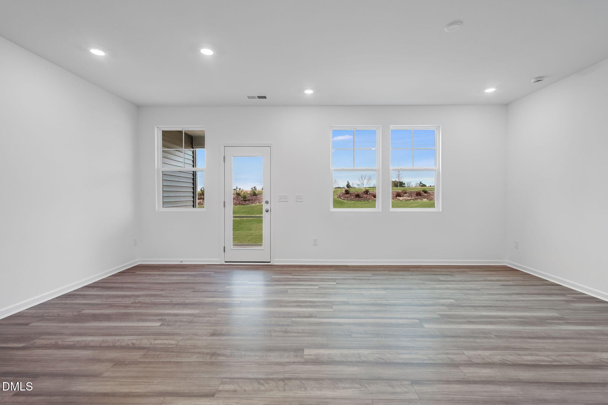 2939 Hickory Fld Drive Raleigh, NC 27616 - Photo 6 of 30 a view of an empty room with wooden floor and a window