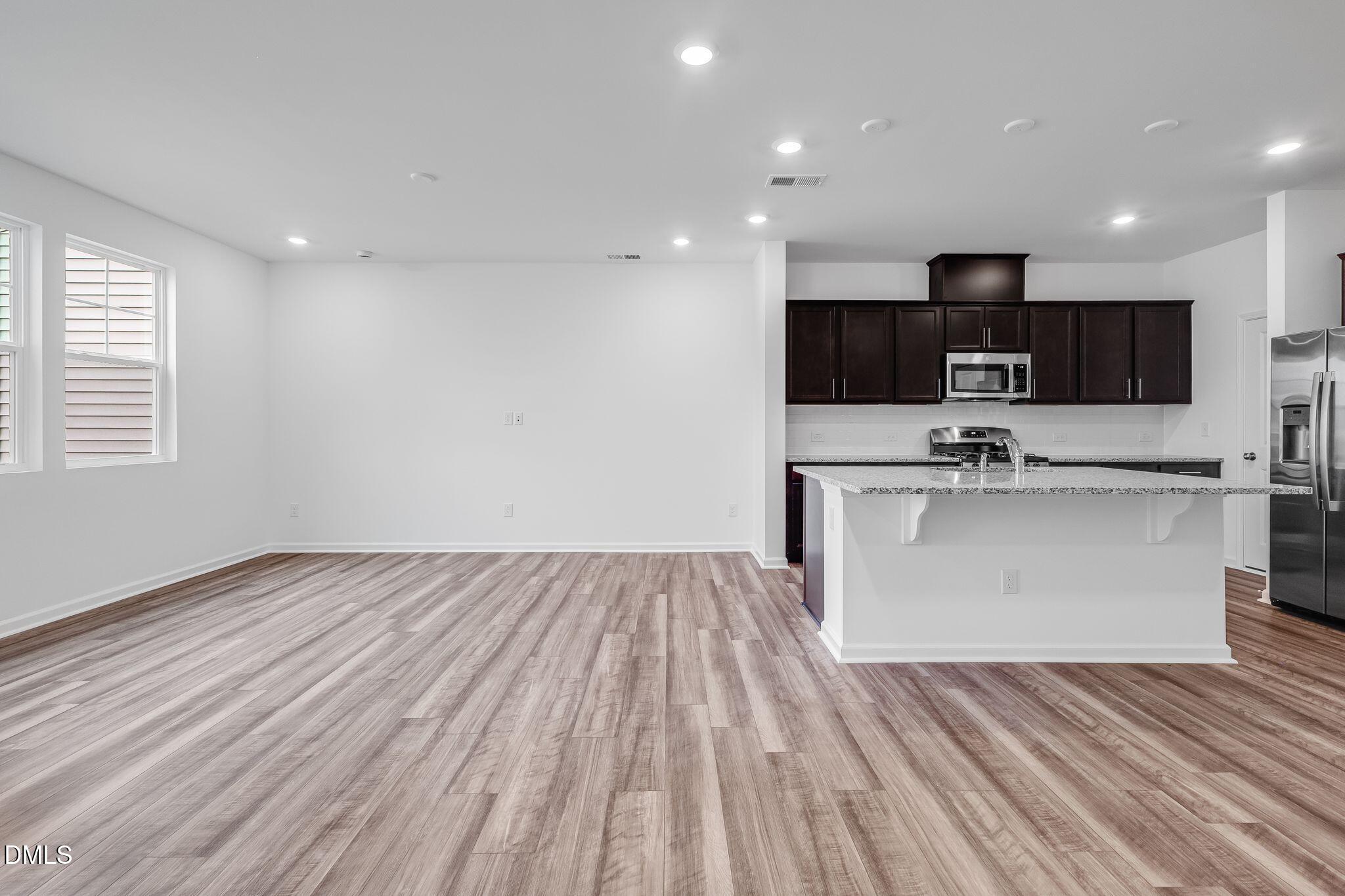 2939 Hickory Fld Drive Raleigh, NC 27616 - Photo 7 of 30 a view of kitchen with stainless steel appliances granite countertop a stove top oven a sink and dishwasher with wooden floor