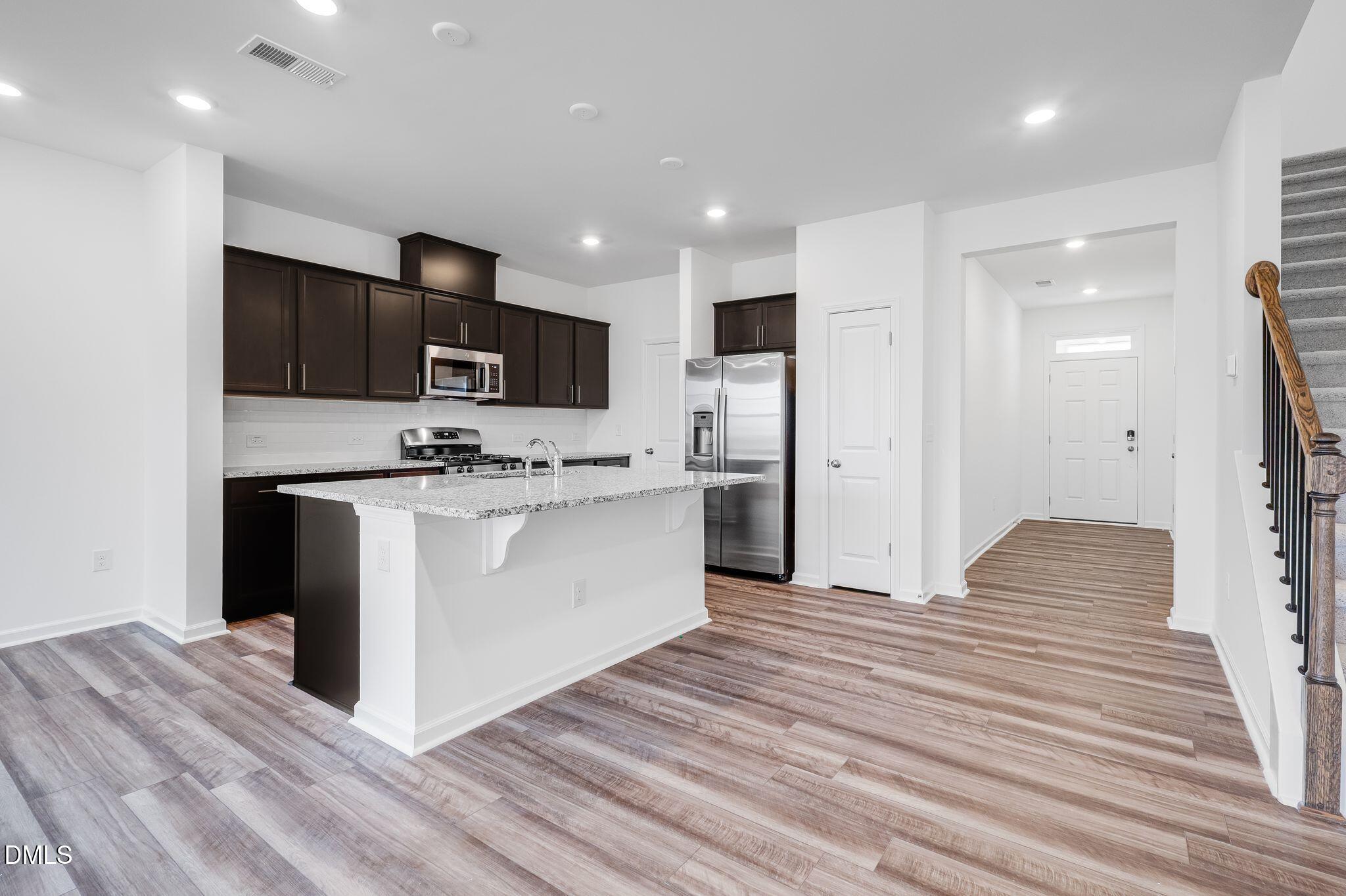 2939 Hickory Fld Drive Raleigh, NC 27616 - Photo 8 of 30 a kitchen with stainless steel appliances a refrigerator stove microwave and cabinets