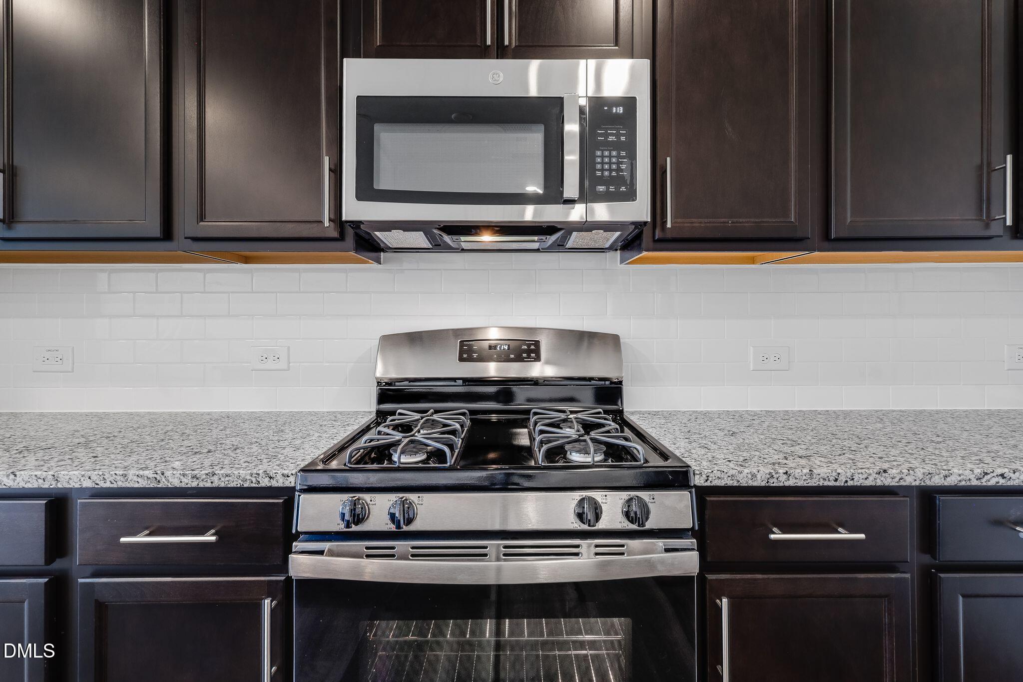 2939 Hickory Fld Drive Raleigh, NC 27616 - Photo 10 of 30 a kitchen with stainless steel appliances granite countertop a stove and a microwave