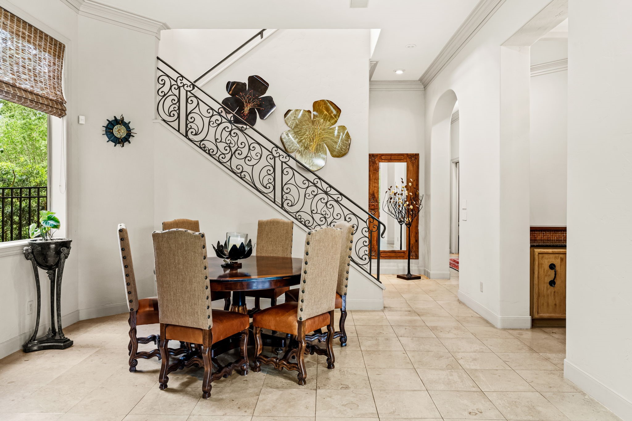 6 Mott Lane Houston, TX 77024 - Photo 32 of 50 Breakfast room perfectly positioned beneath an elegant staircase with wrought iron detailing. This inviting areas offers the ideal setting for intimate dining or a stylish workspace.