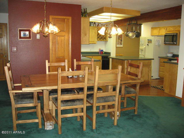 2935 Deer Hill Road Heber, AZ 85928 - Photo 6 of 14 a view of a dining room with furniture and a chandelier