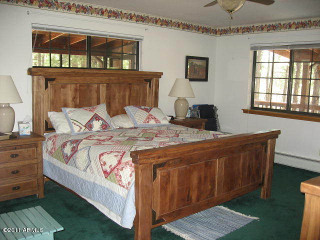 2935 Deer Hill Road Heber, AZ 85928 - Photo 9 of 14 a bedroom with a bed and a window
