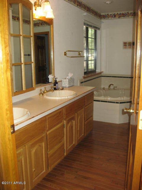 2935 Deer Hill Road Heber, AZ 85928 - Photo 10 of 14 a bathroom with a tub sink and mirror