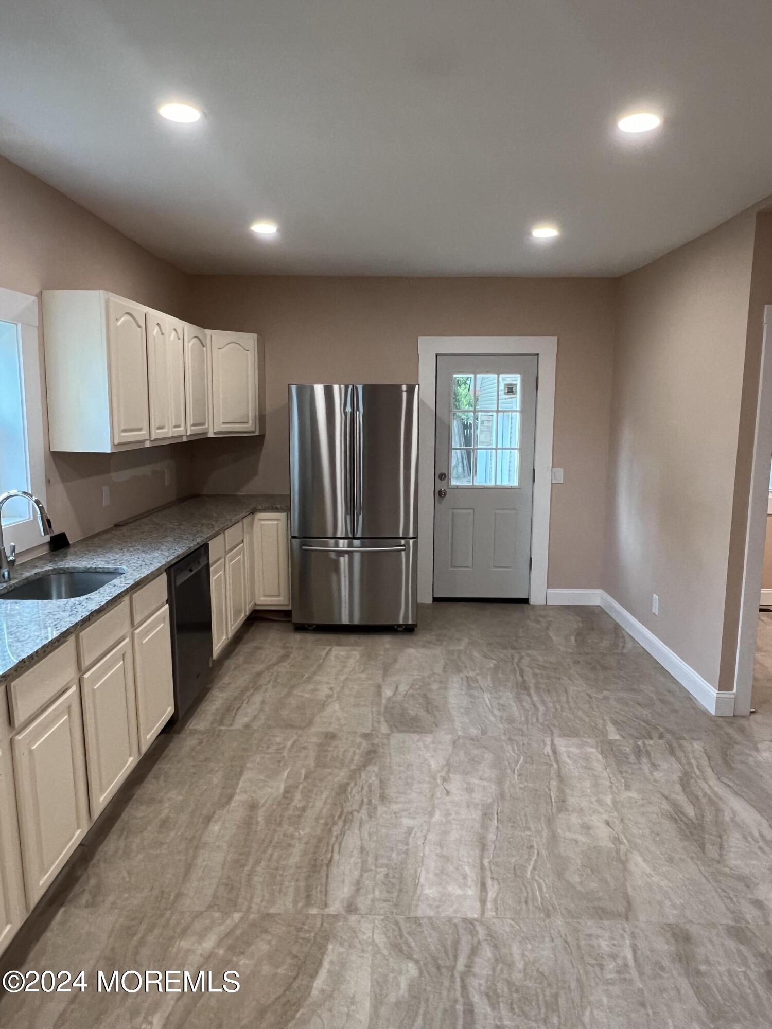 815 Clark Street, Unit 1 Point Pleasant, NJ 08742 - Photo 3 of 10 a view of a kitchen with refrigerator and microwave
