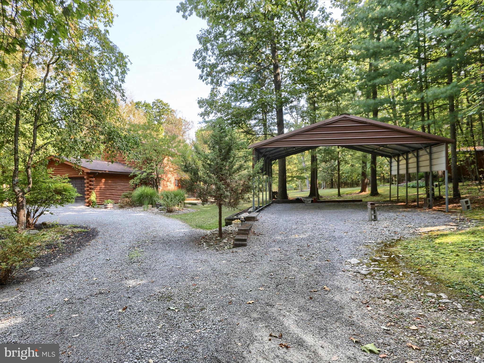 333 Mauger Path Road Port Royal, PA 17082 - Photo 38 of 58 a view of a yard with a table and chairs under an umbrella