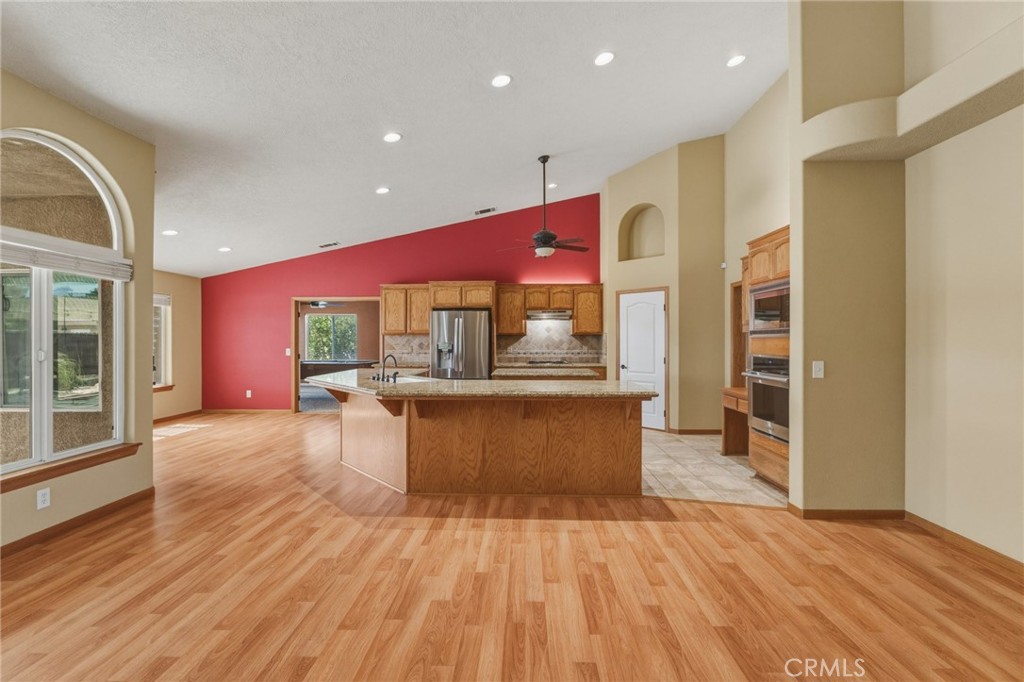 19501 Kinai Road Apple Valley, CA 92307 - Photo 13 of 49 a kitchen with stainless steel appliances kitchen island wooden cabinets and granite counter tops