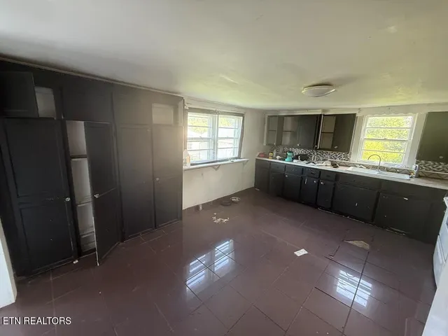 a kitchen with granite countertop a stove and refrigerator