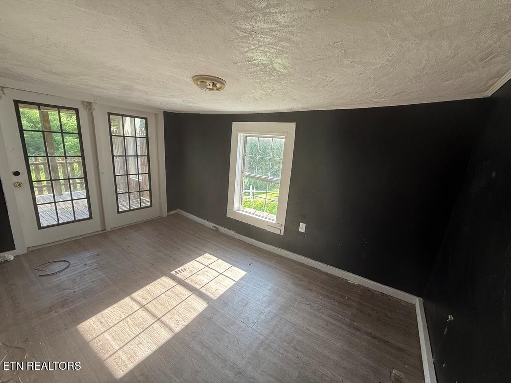 7224 Thomas Twin Oaks Road Baxter, TN 38544 - Photo 22 of 26 a view of an empty room with glass door and windows