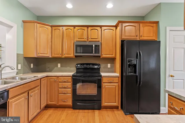 a kitchen with a refrigerator stove and sink