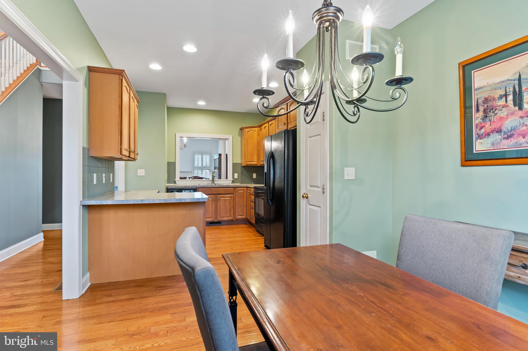 1920 Roxbury Court Mechanicsburg, PA 17055 - Photo 15 of 34 a kitchen with stainless steel appliances granite countertop a table chairs in it and wooden floors