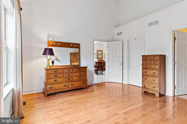 a dining room with wooden floor and a window