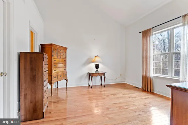 a view of a bedroom with furniture window and wooden floor