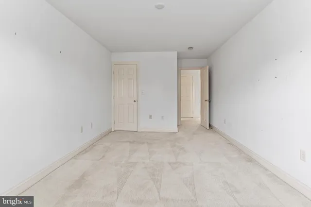 a view of an empty room and wooden floor