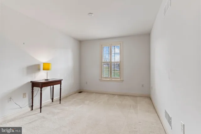 a bathroom with a granite countertop sink a toilet and a mirror