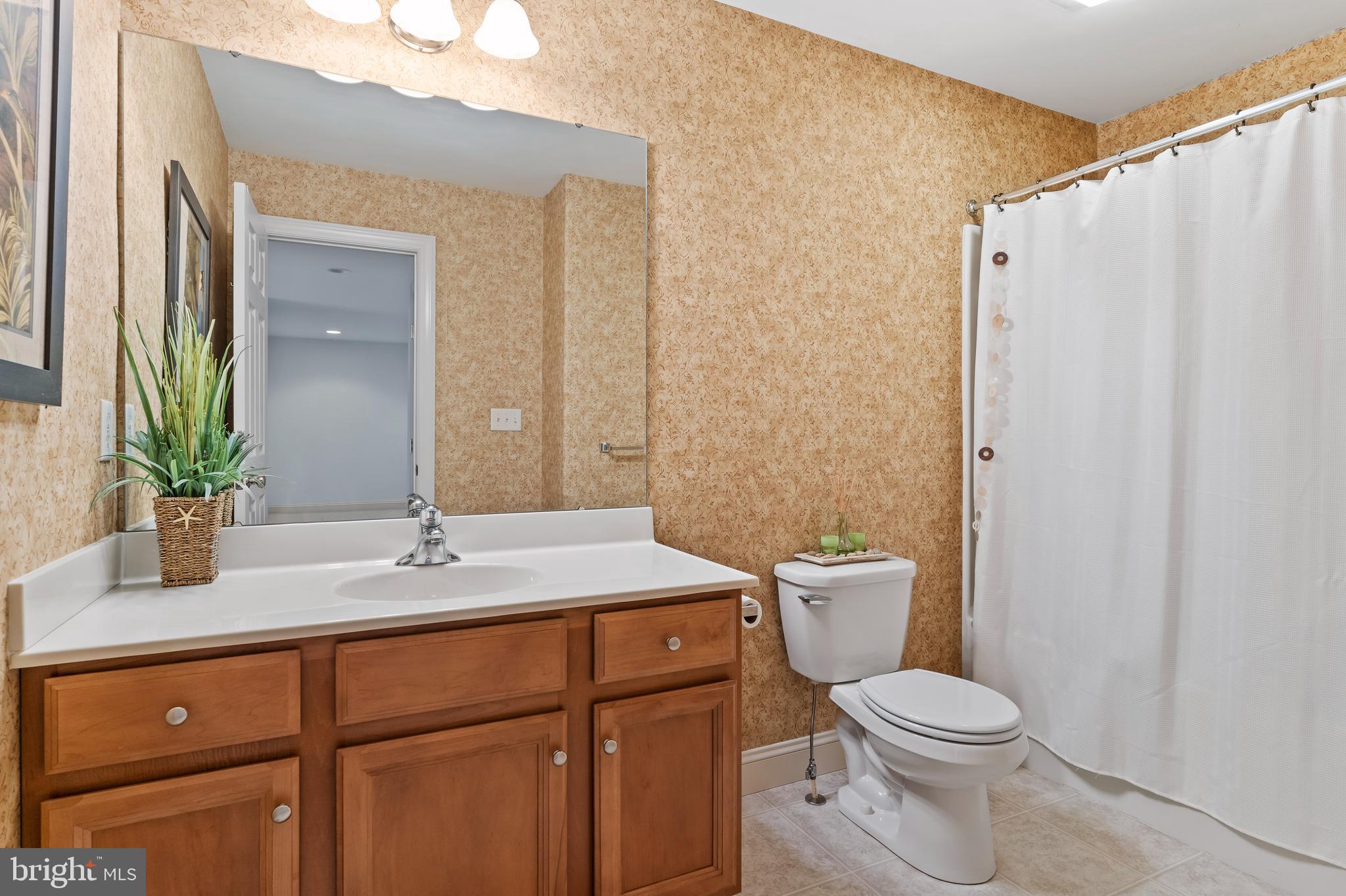 1920 Roxbury Court Mechanicsburg, PA 17055 - Photo 30 of 34 a bathroom with a granite countertop sink a toilet and a mirror