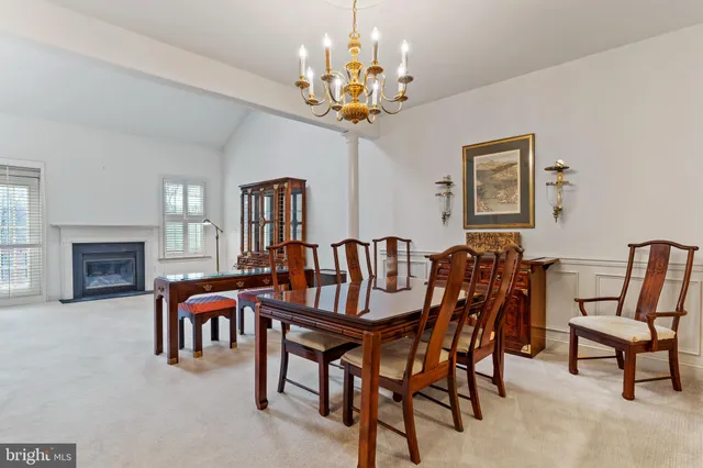 a view of a dining room with furniture and a chandelier