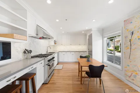 a large kitchen with granite countertop lots of counter space and sink