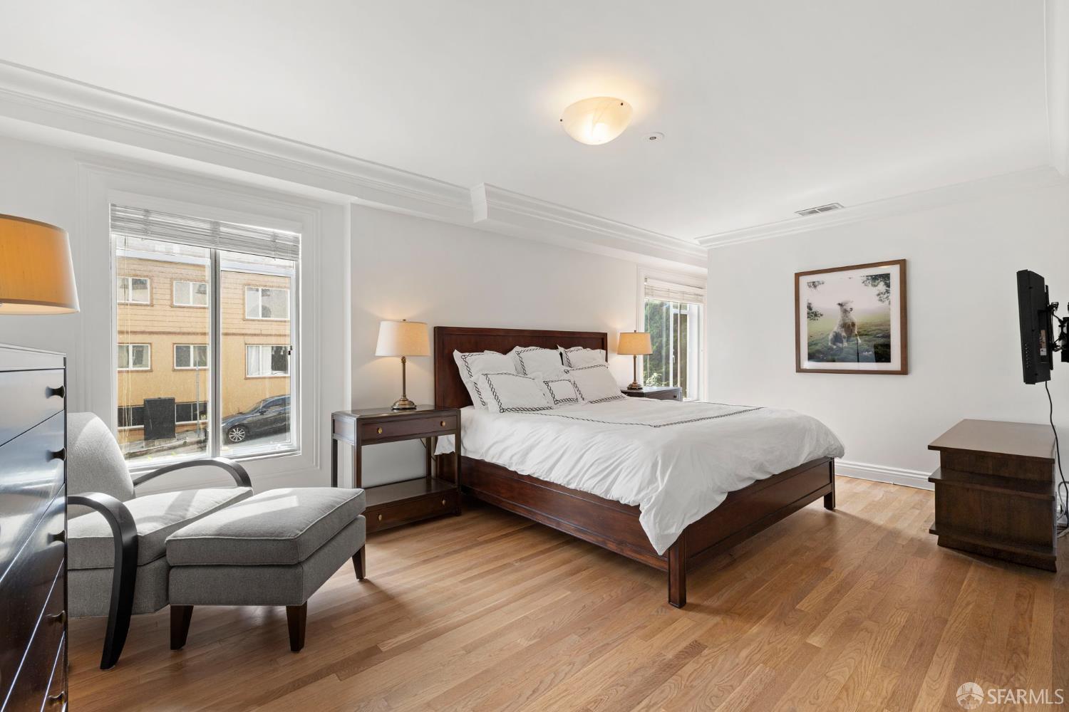 2145 Franklin Street, Unit 1 San Francisco, CA 94109 - Photo 23 of 46 a bedroom with a bed wooden floor and lamp