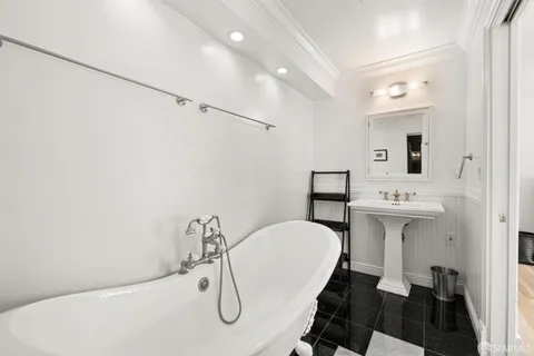 a bathroom with a sink mirror and toilet