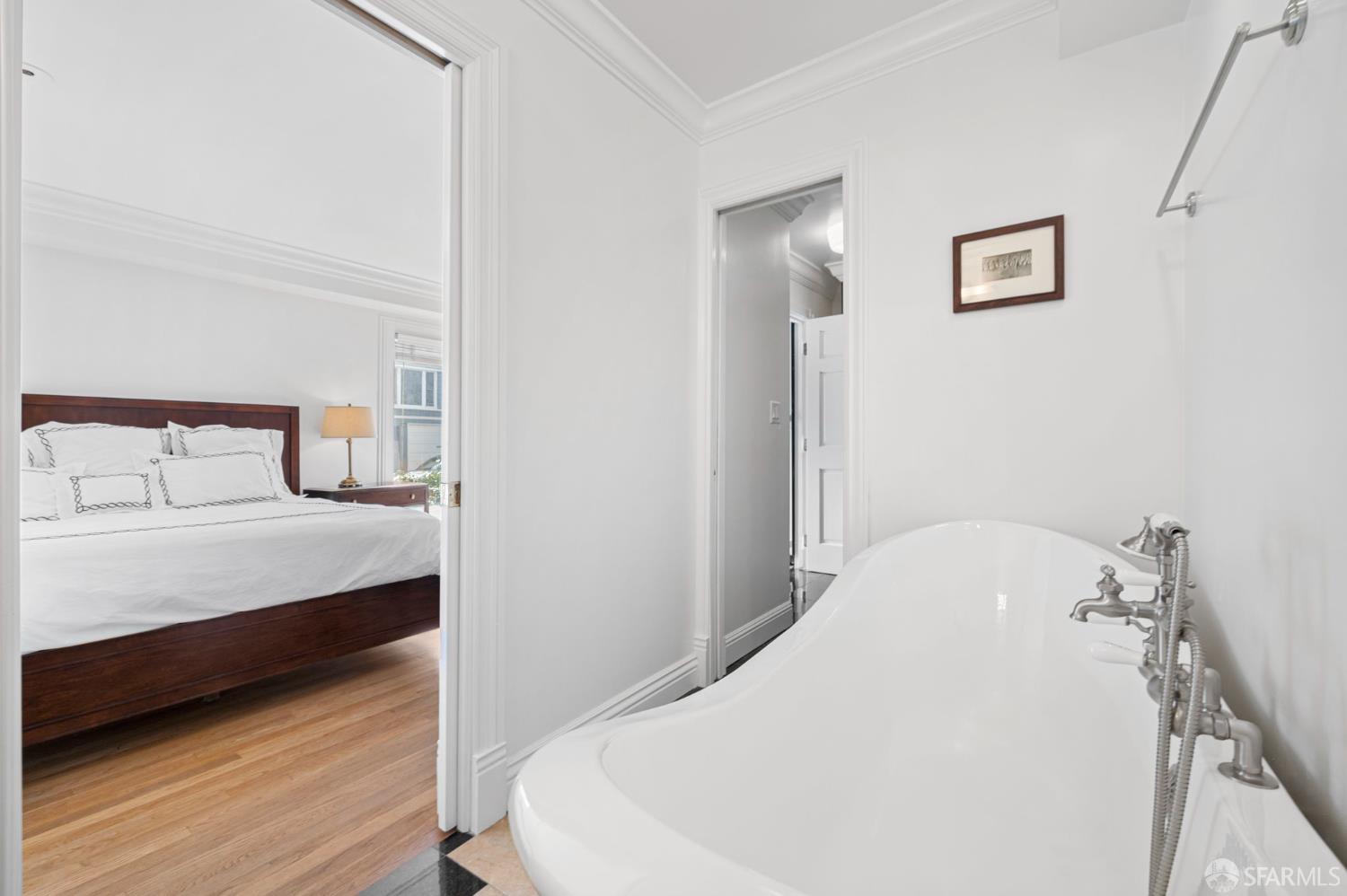 2145 Franklin Street, Unit 1 San Francisco, CA 94109 - Photo 27 of 46 a bedroom with a bed and wooden floor