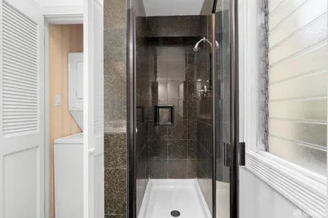 a bathroom with a glass shower door