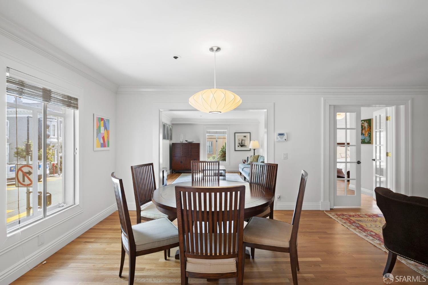 2145 Franklin Street, Unit 1 San Francisco, CA 94109 - Photo 10 of 46 a view of a dining room with furniture window and wooden floor