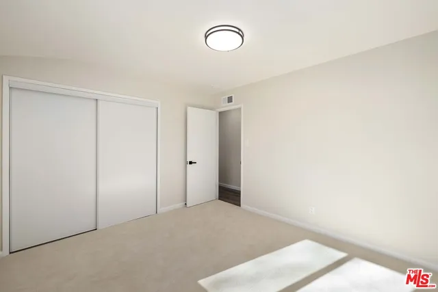 a view of a room with wooden floor and window
