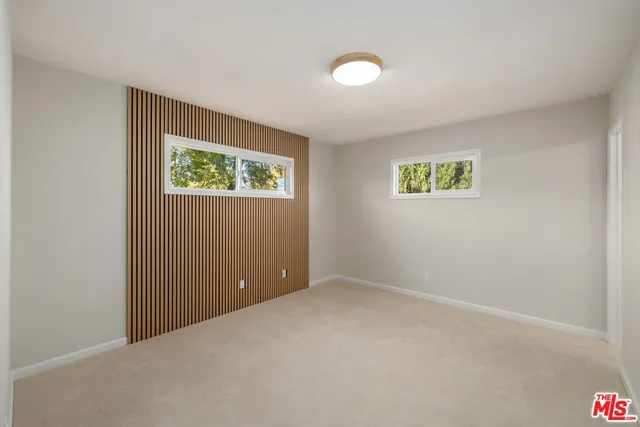 an empty room with windows and wall