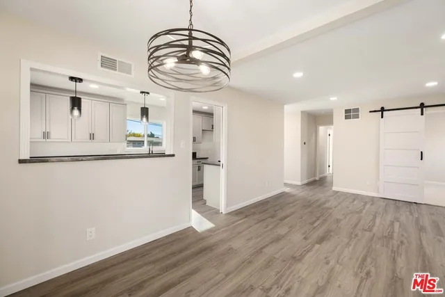a view of a kitchen with a dishwasher and wooden floor