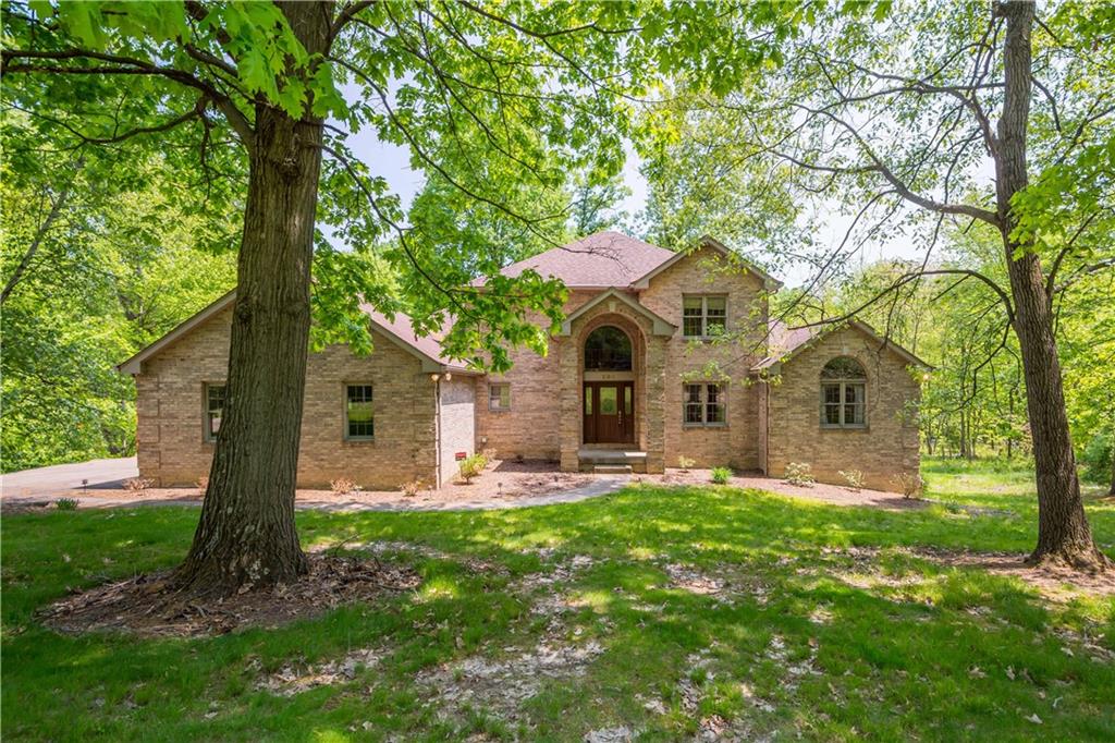 a front view of house with yard and green space