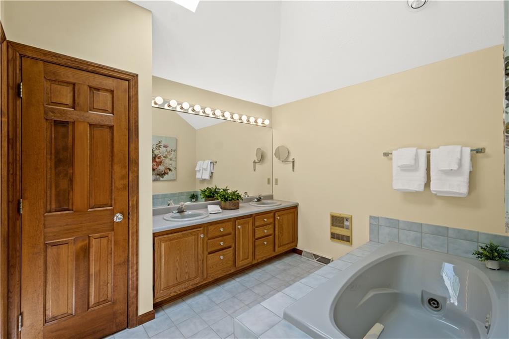 203 Oak Leaf Drive Mars, PA 16046 - Photo 14 of 25 a bathroom with a tub sink and mirror