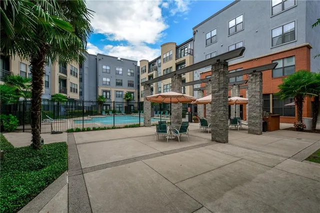 a view of a building with sitting area and garden