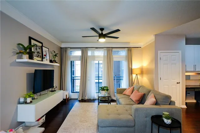 a living room with furniture a fireplace and a large window