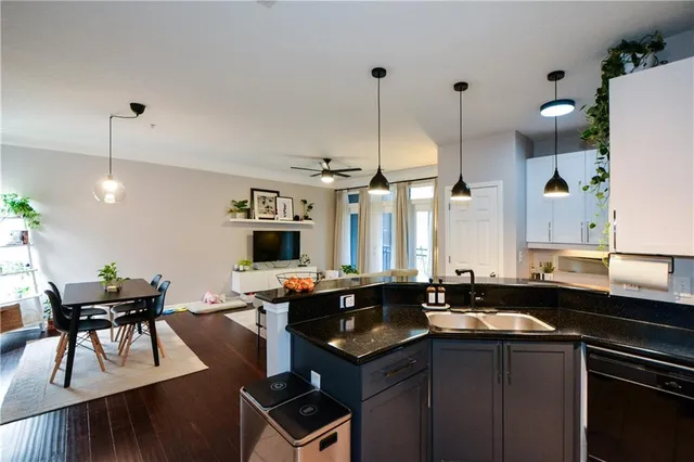 a kitchen with granite countertop a sink and cabinets